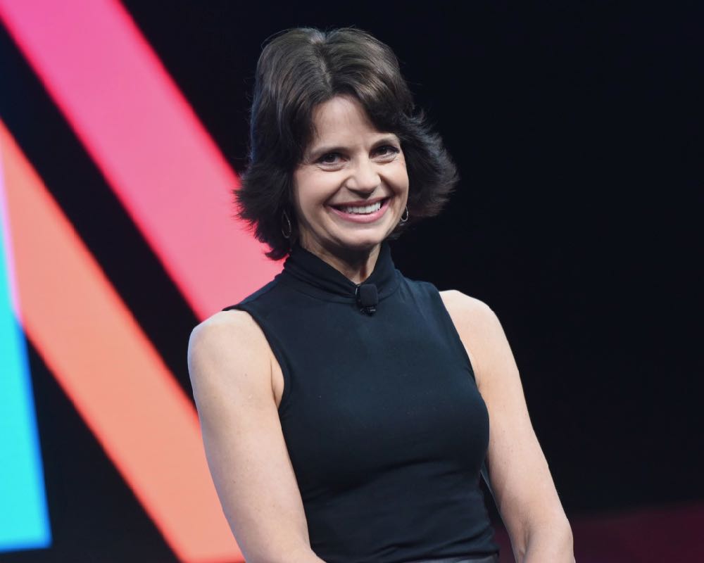 During a motivational speaking engagement, Lisa McCarthy smiles at the audience from the stage