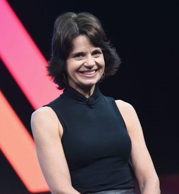 Motivational Speaker Lisa McCarthy smiles on stage at the audience while speaking at the 2018 Makers Conference in Los Angeles